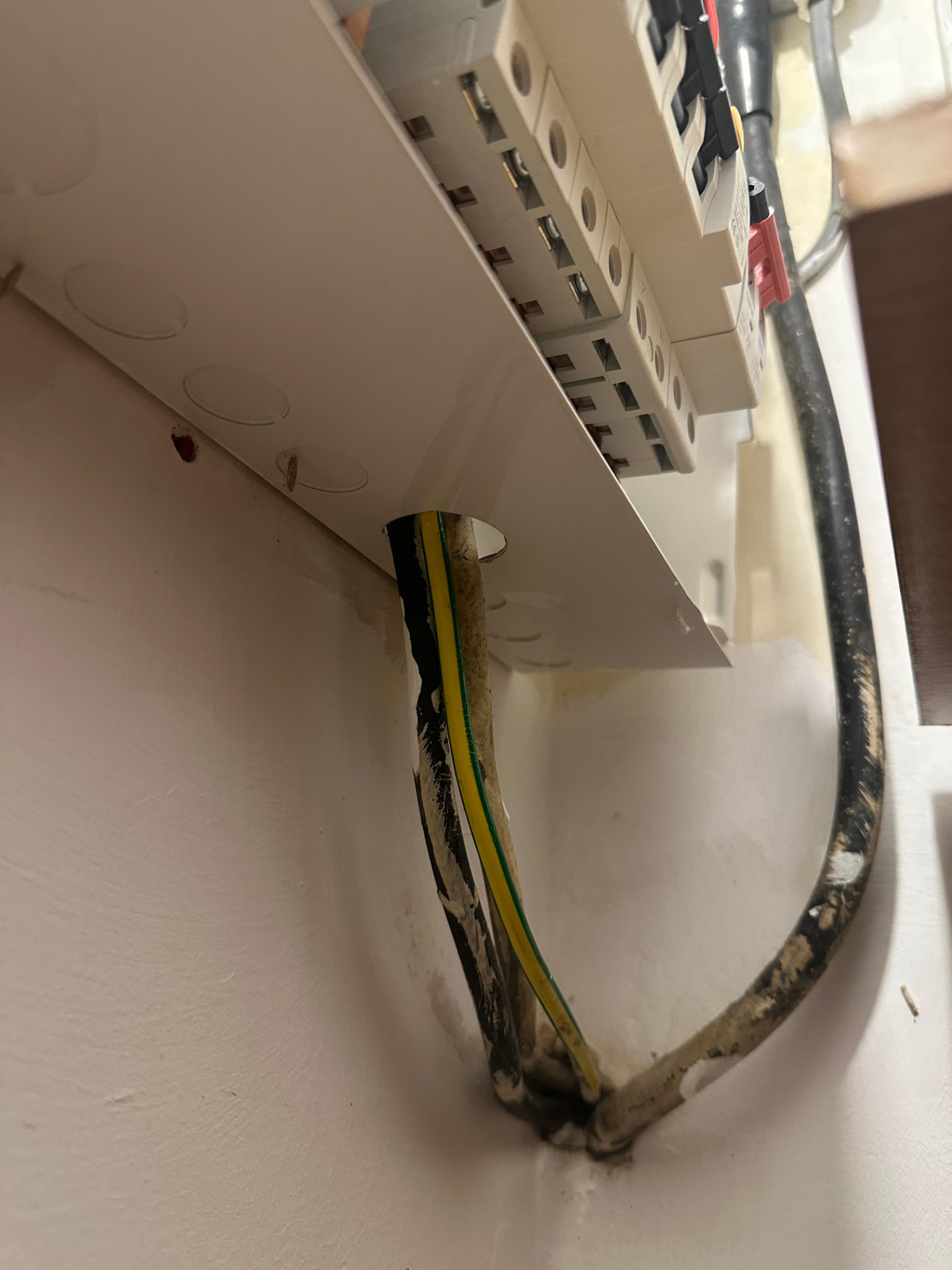 Damaged cable entry into consumer unit revealed during an EICR periodic inspection