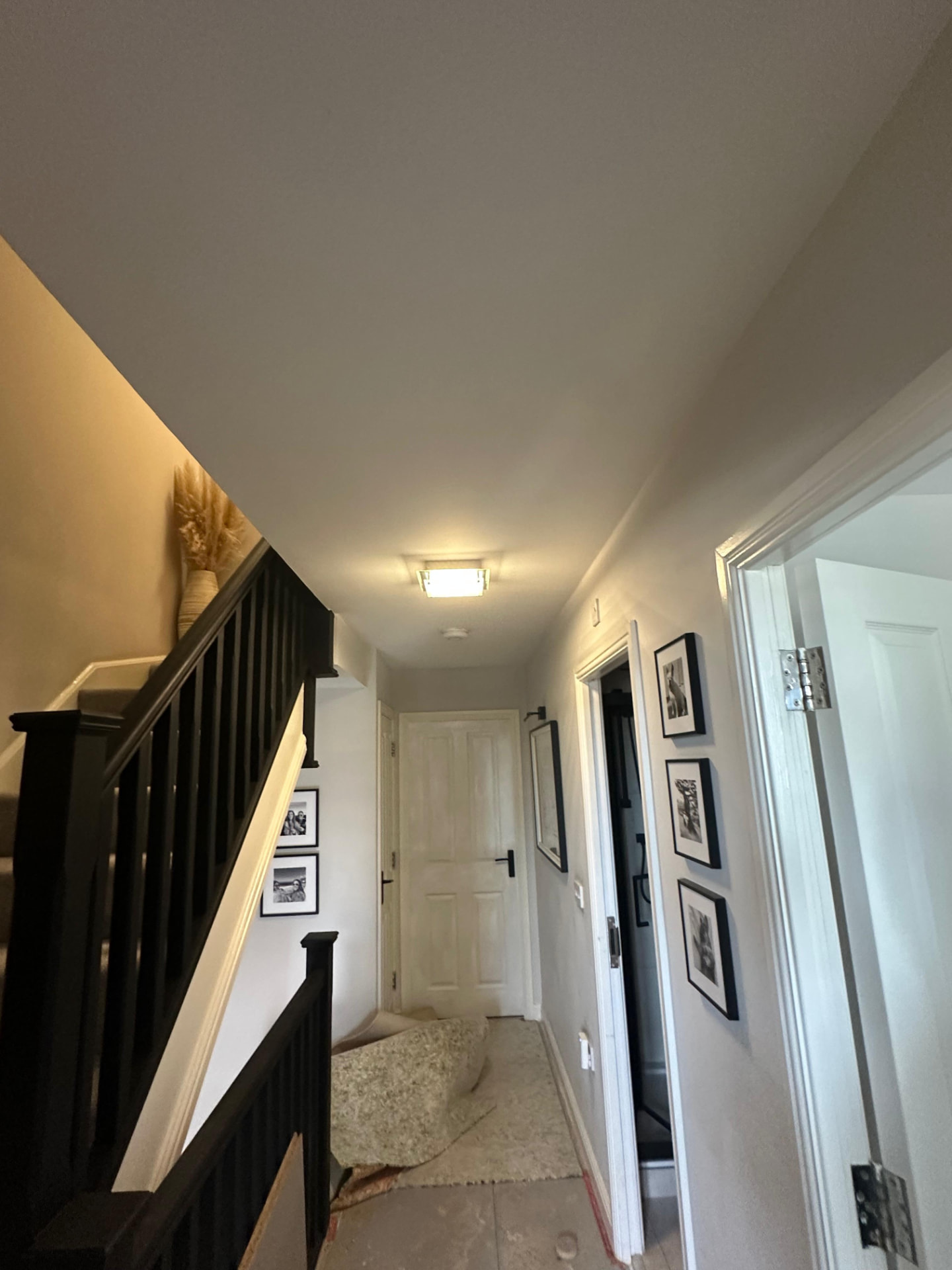 Hallway ceiling downlights installed to a residential landing area